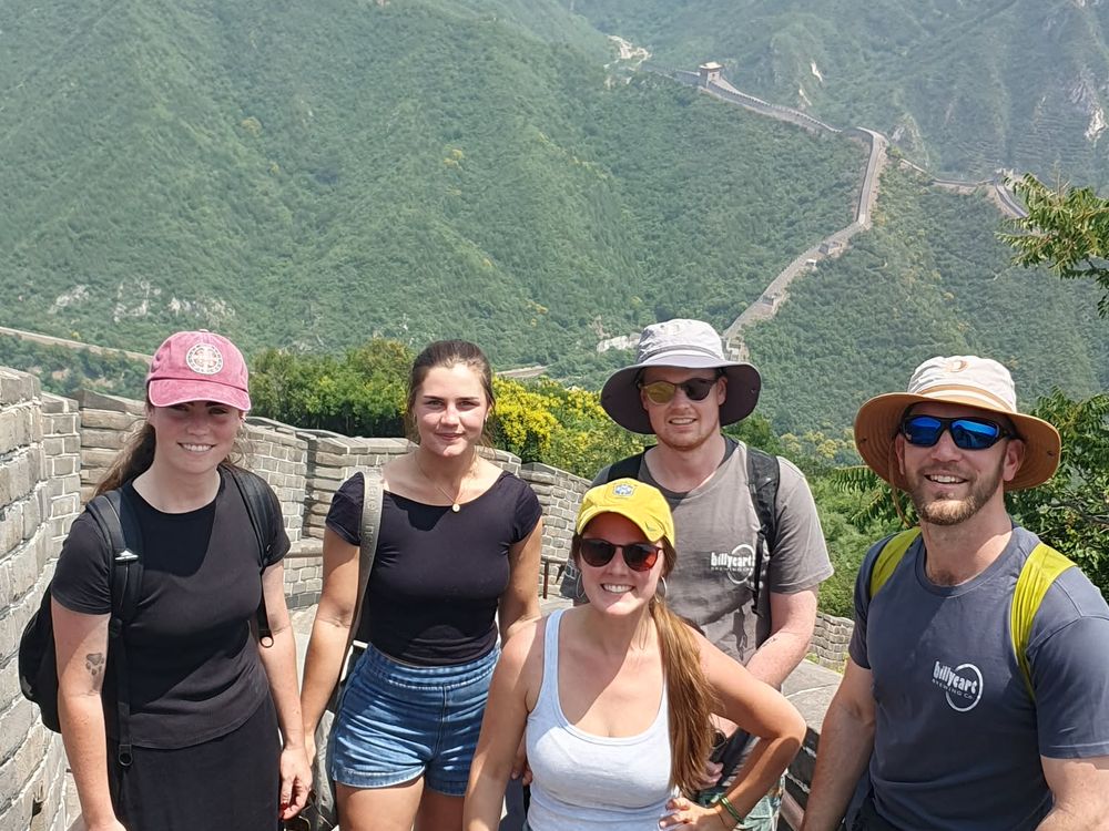 The group on a section of the Great Wall of China winding over the hills