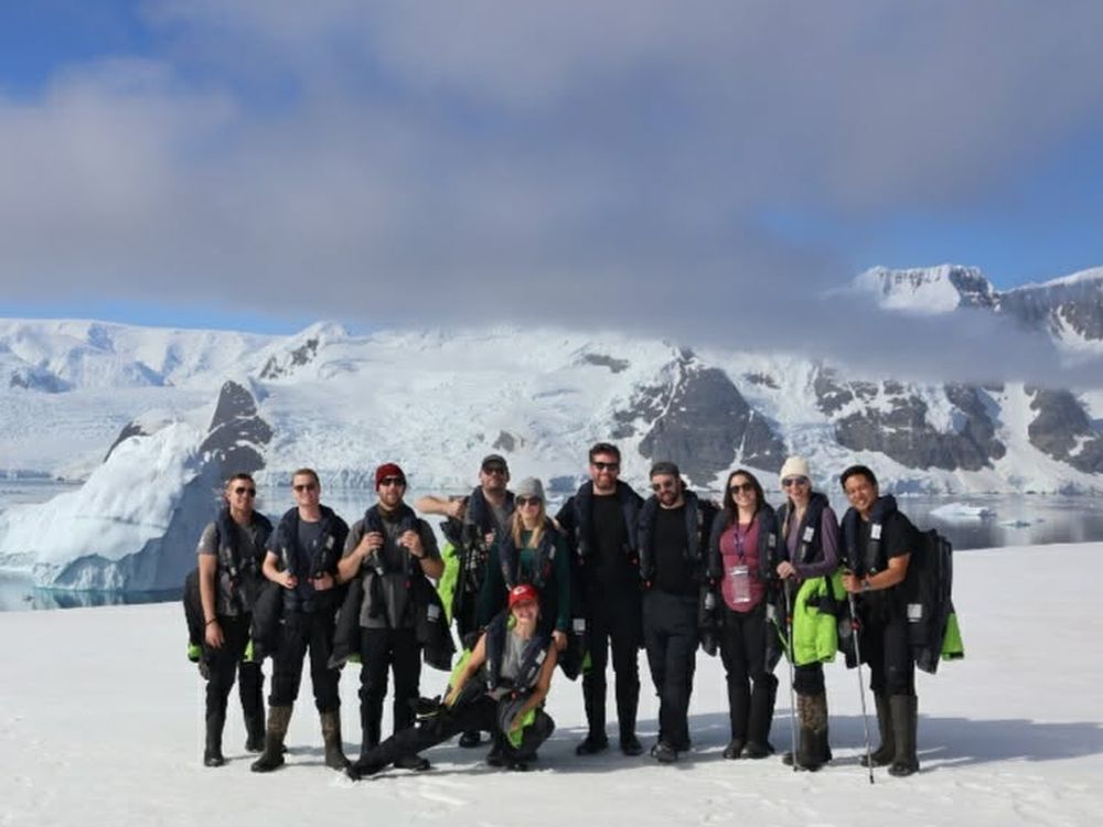 The group posing in front of a glacier and snowfield in Chilean Patagonia